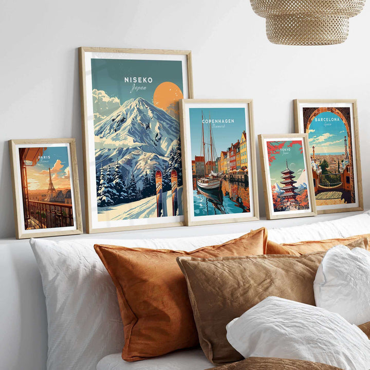 Collection of framed travel posters featuring Niseko ski print and global cityscapes, displayed on a stylish living room shelf.