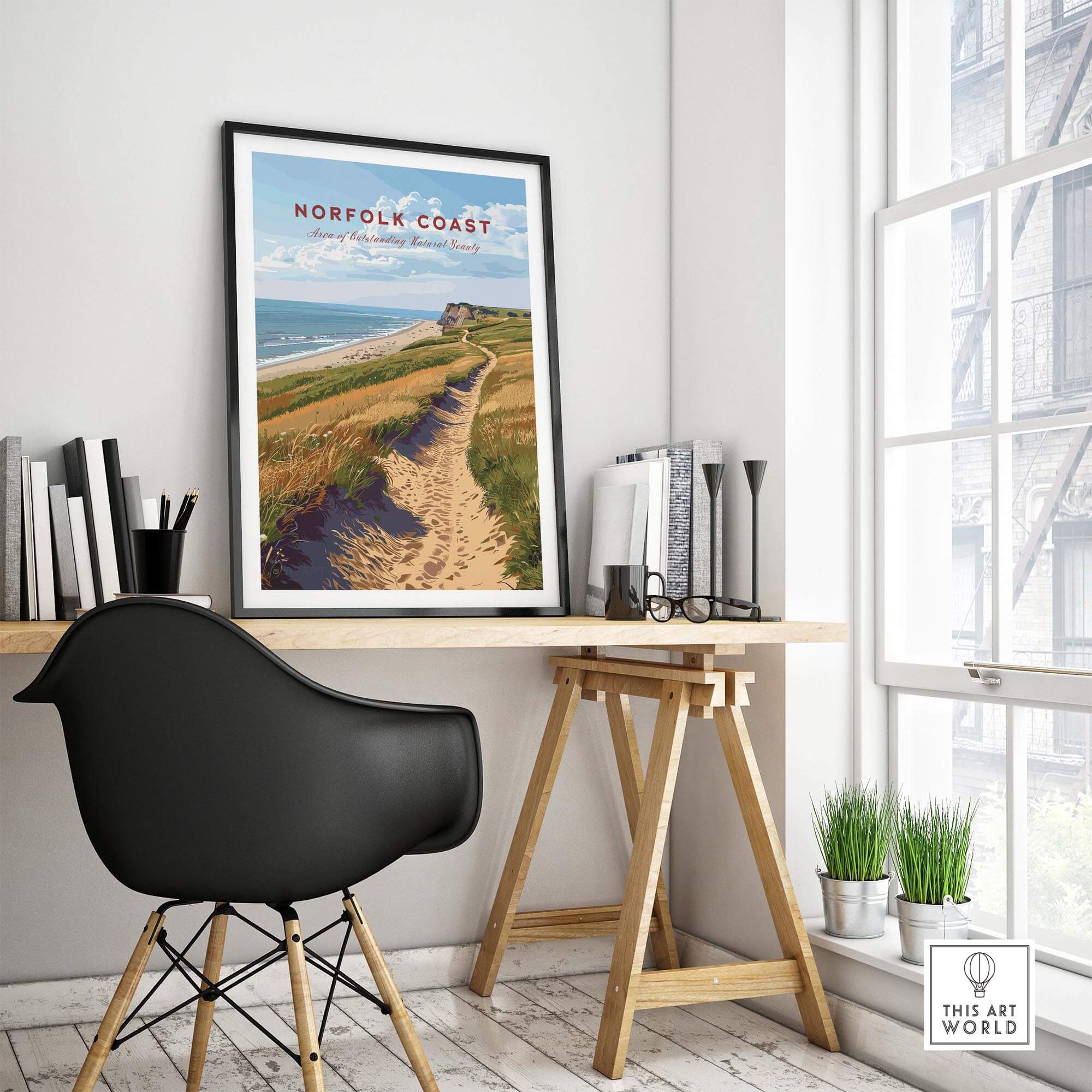Norfolk Coast Poster displayed in a modern home office setting with a stylish chair and desk.