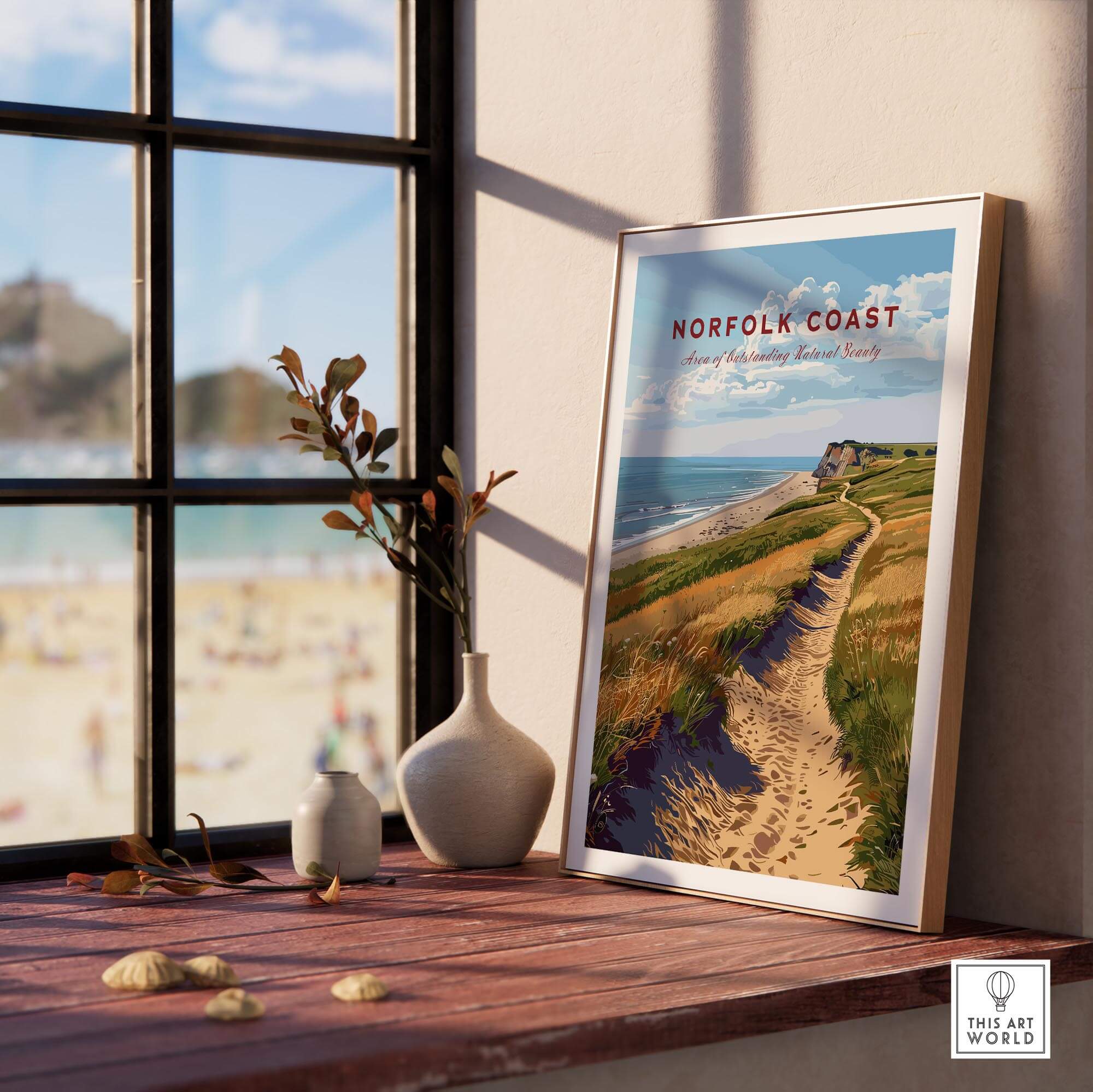 Norfolk Coast Poster framed on a windowsill showcasing sandy paths and stunning coastal views.