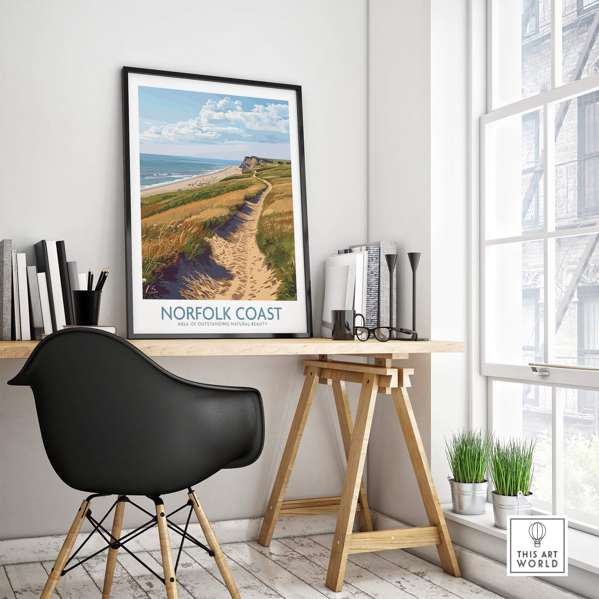 Norfolk Coast Print displayed in a cozy home office setting, showcasing beautiful coastal scenery.