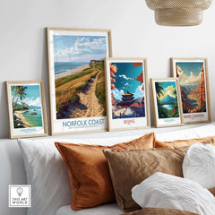 Norfolk Coast Print showcased among various travel art prints on a stylish couch with natural decor.