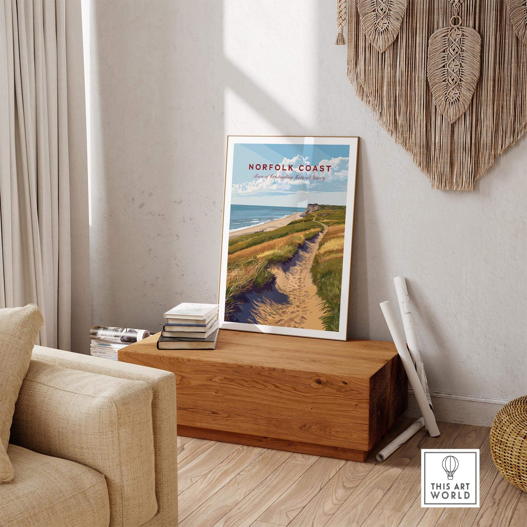 Norfolk Coast Travel Poster displayed in a cozy living room with natural decor and wooden furniture.