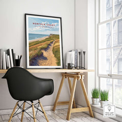 Norfolk Coast Travel Poster displayed in a stylish home office setting with modern decor and natural light.
