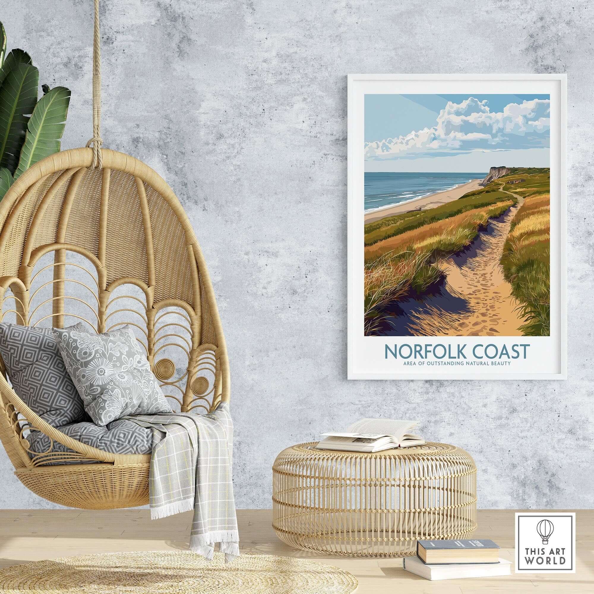 Norfolk Coast Travel Print displayed in a cozy interior with a hanging chair and decorative elements.