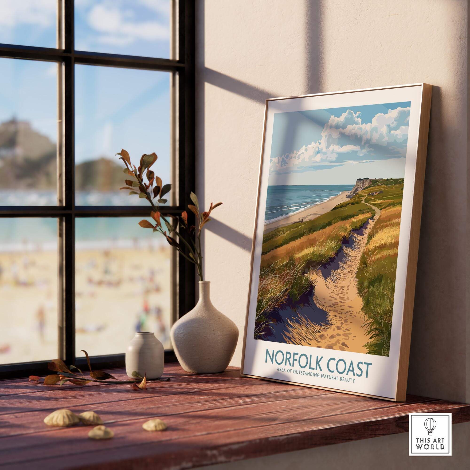Norfolk Coast Travel Print framed on a table showcasing the scenic beauty of Norfolk's coastline
