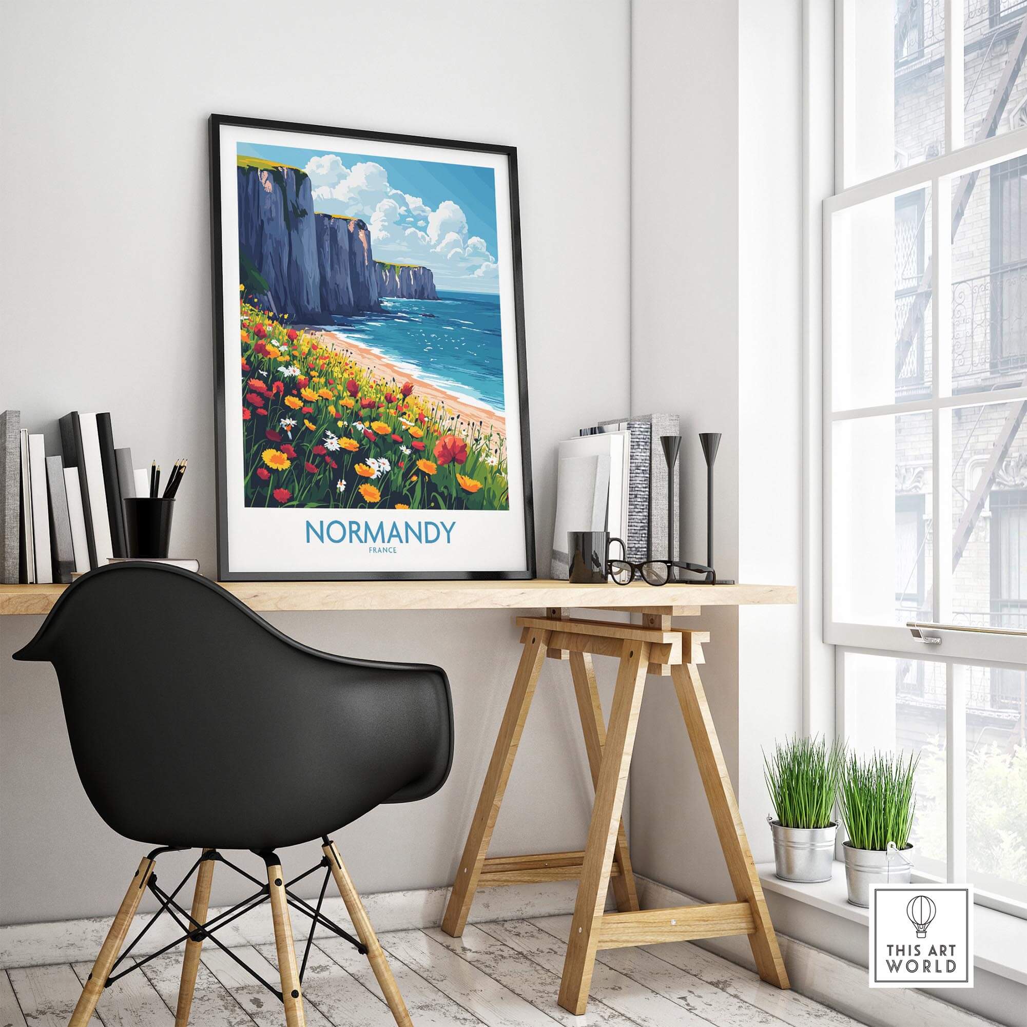 Normandy Wall Art Poster displayed in a modern home office, featuring a coastal landscape with flowers.