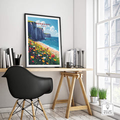 Normandy Wall Art Print showcasing coastal cliffs and vibrant flowers in a modern workspace setting.
