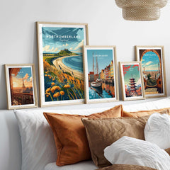 Northumberland Coast Print displayed among various travel prints in a stylish home setting