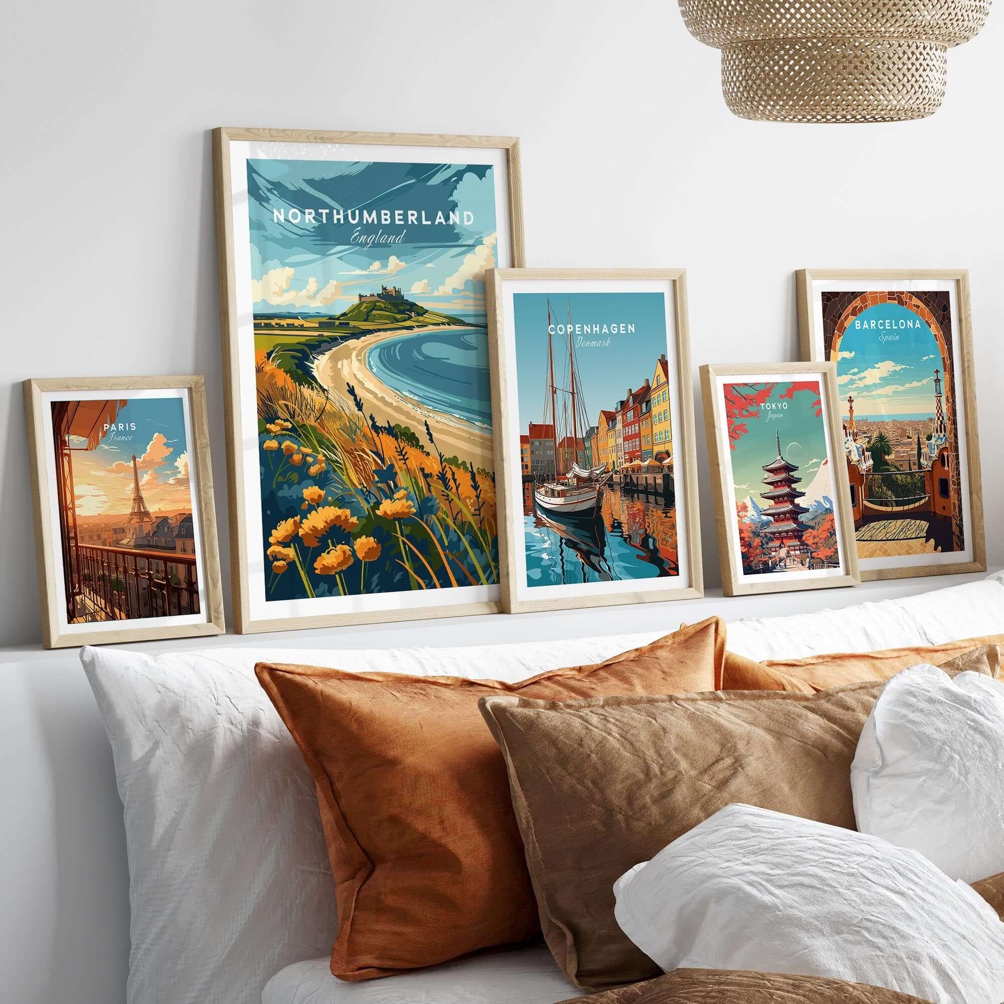 Northumberland Coast Print displayed among various travel prints in a stylish home setting