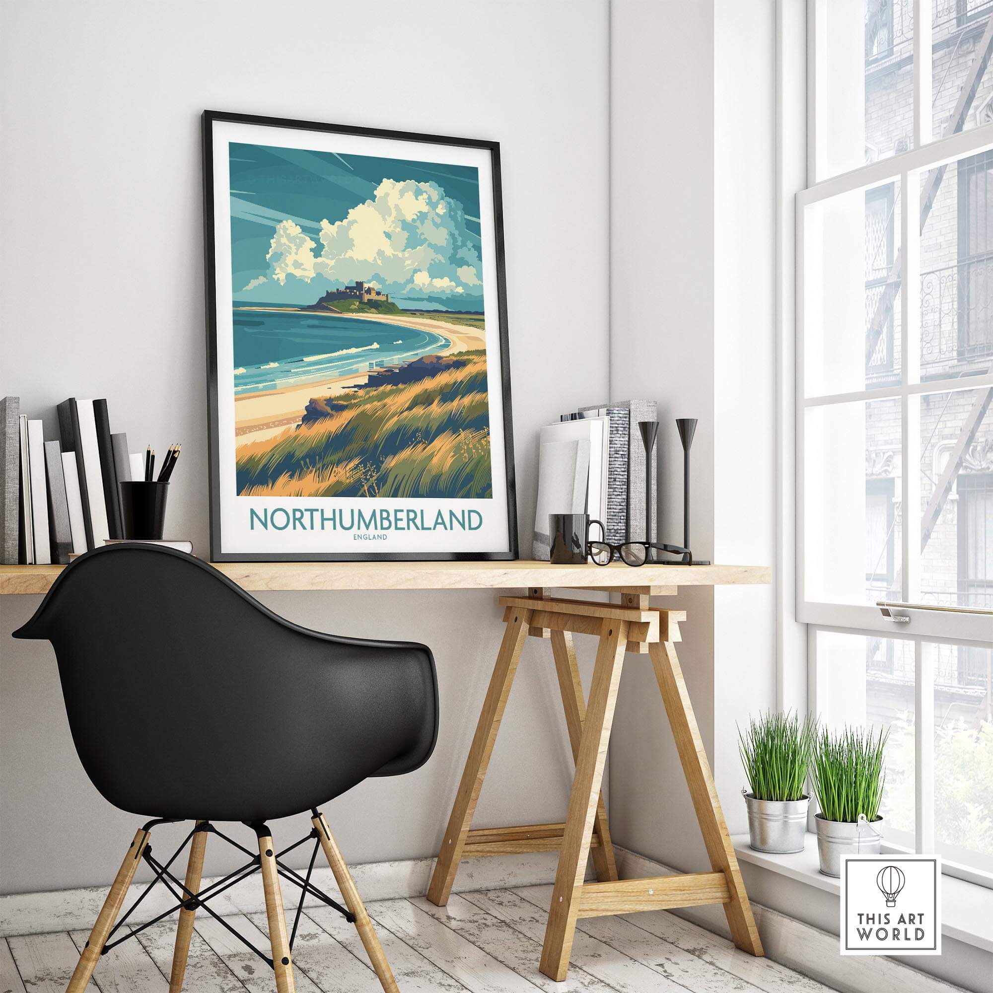 Northumberland Coast Travel Poster displayed in a modern workspace, featuring the scenic coastline and clouds.