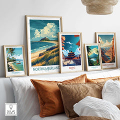 Northumberland Coast Travel Poster displayed among other travel posters on a stylish living room wall.