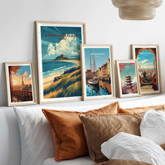Northumberland Coast Travel Print displayed among other travel prints on a cozy living room wall.