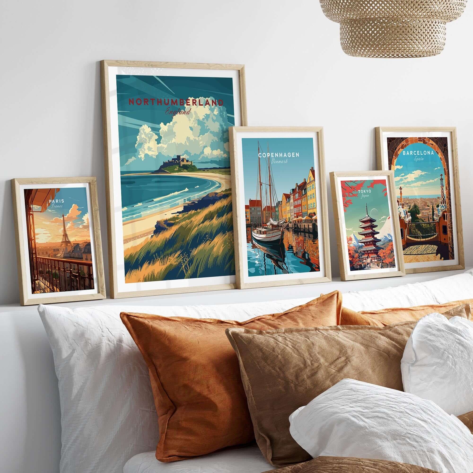 Northumberland Coast Travel Print displayed among other travel prints on a cozy living room wall.