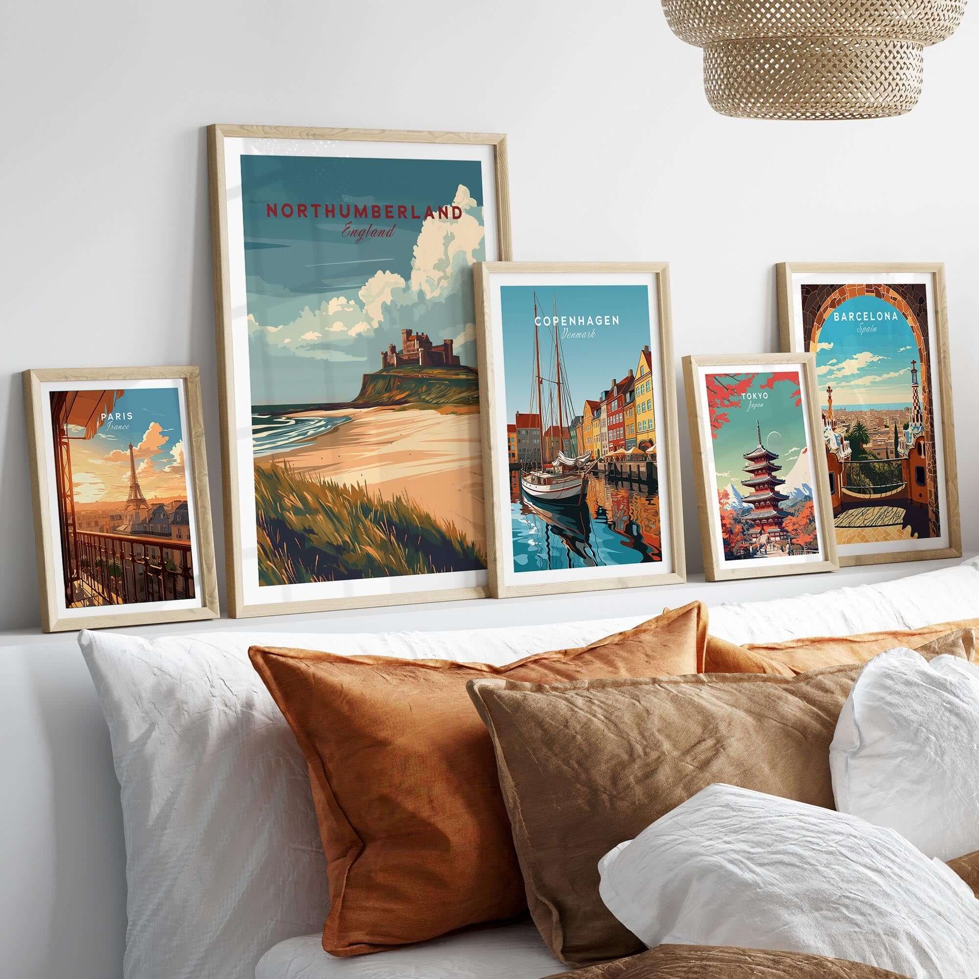 Northumberland Wall Art Print - Bamburgh Castle displayed among coastal and city skyline prints on a stylish wall.
