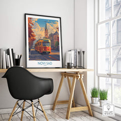 Novi Sad Travel Poster - Serbia featuring a vibrant tram scene in an elegant workspace setting.