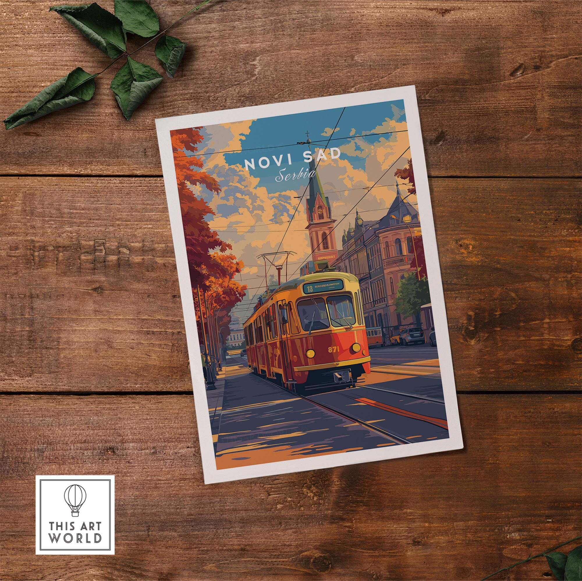 Novi Sad Travel Print - Serbia featuring a colorful tram and iconic architecture on a wooden background.