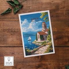 Ohrid Wall Art showcasing a serene lakeside scene with a historic building, perfect for home decor and travel enthusiasts.