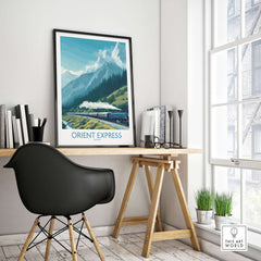Orient Express Poster - Steam Train Art Print displayed in a modern workspace with mountains in the background.