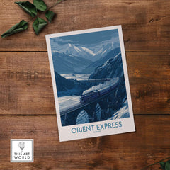 Orient Express Print | Snowy Mountain Poster featuring a train crossing snowy mountains and a river.