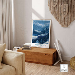 Orient Express Print | Snowy Mountain Poster displayed in a cozy living room setting with wooden decor.