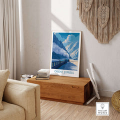 Orient Express Train Print | Snowy Alps Journey Poster displayed in a cozy living room with alpine scenery.