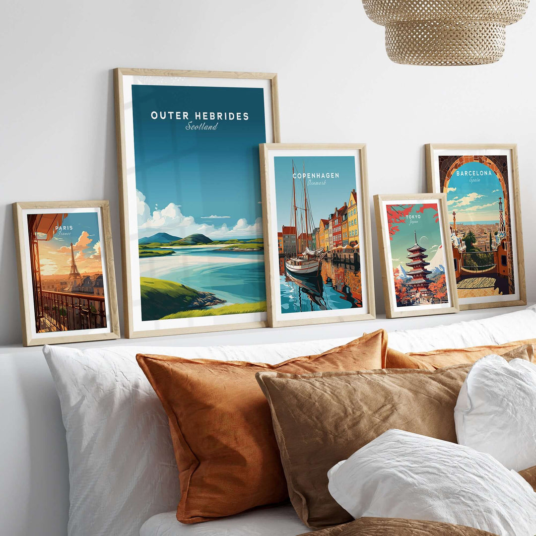 Outer Hebrides art print displayed with other travel posters above a cozy sofa, showcasing minimalist Scottish landscapes.