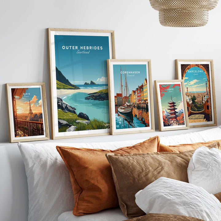 Outer Hebrides Art Print displayed on a wall above a couch with decorative pillows, showcasing coastal and city landscapes.