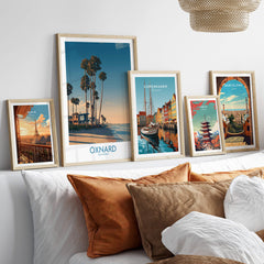 Oxnard Poster | California Beach House Sunset Canvas Print displayed on a cozy bed with decorative pillows.