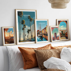 Oxnard California Wall Art Print | Palm Tree Lined Coastal Travel Poster styled on a sofa with other travel posters.