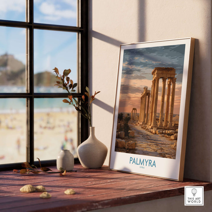 Palmyra poster art print showcasing ancient Syrian architecture placed on a windowsill with a beach view.