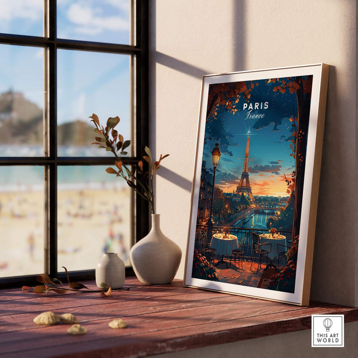 Paris travel print featuring the Eiffel Tower, framed and displayed on a sunlit table by a window with beach view.