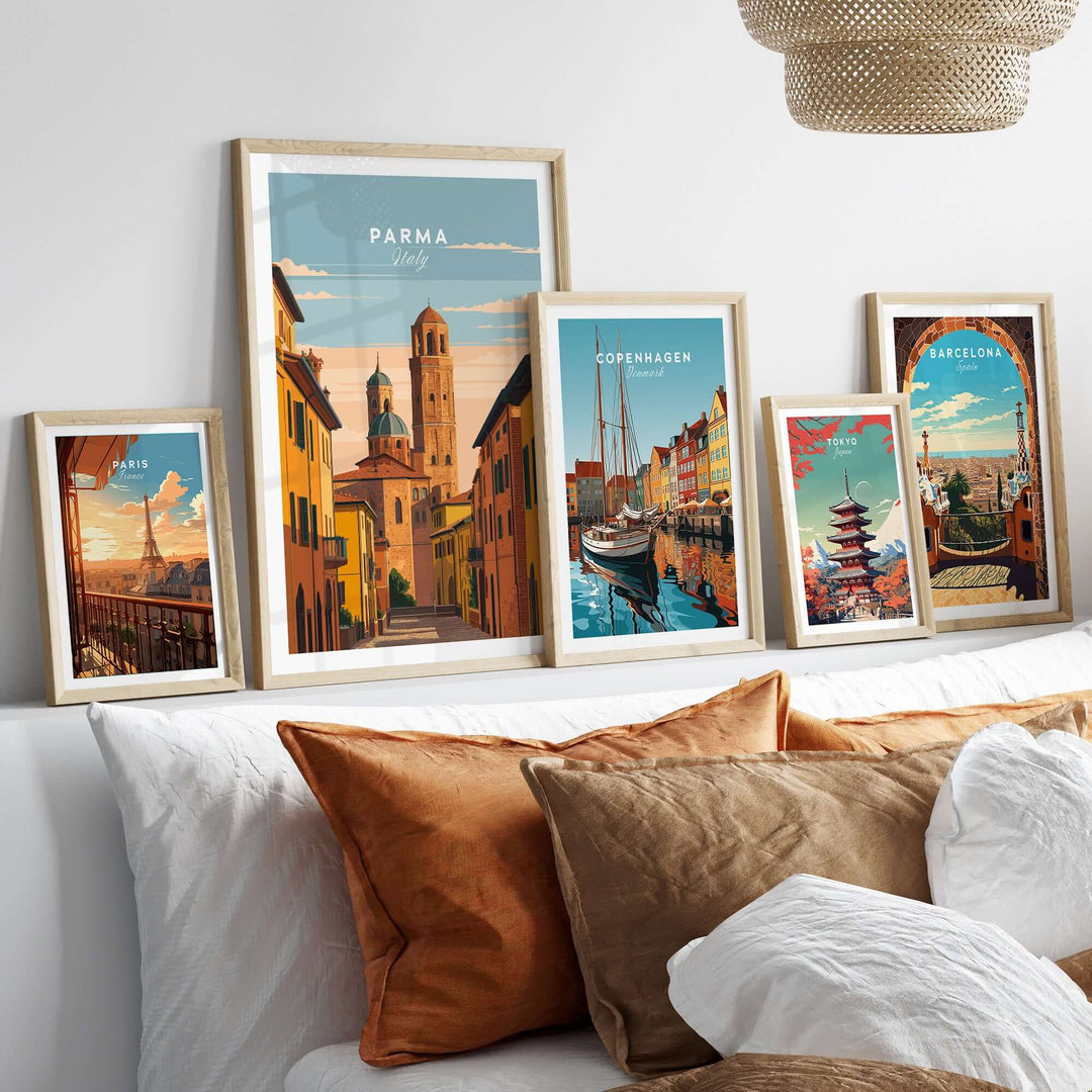 Framed Parma art print among various city posters on a stylish sofa, showcasing European culture and charm.