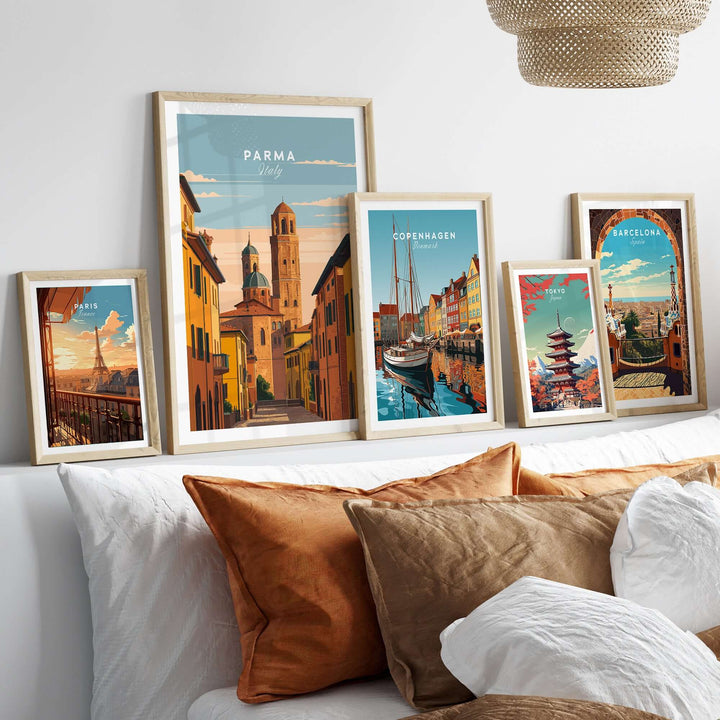 Framed Parma art print among various city posters on a stylish sofa, showcasing European culture and charm.