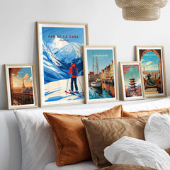 Pas de la Casa Grandvalira Ski Print | Winter Sports Wall Decor displayed among other travel prints on a cozy sofa.