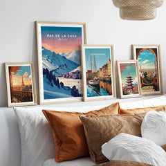 Pas de la Casa Wall Art | Andorra Travel Print displayed among other travel prints on a cozy sofa.