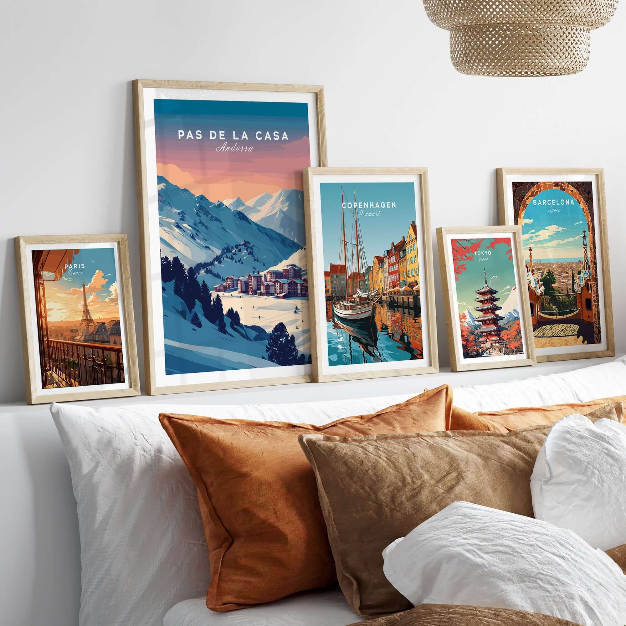 Pas de la Casa Wall Art | Andorra Travel Print displayed among other travel prints on a cozy sofa.