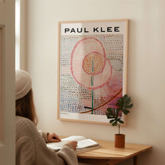 Paul Klee Blossoming Abstract Floral Modern Poster Art Print Decor displayed on wall with viewer reading.