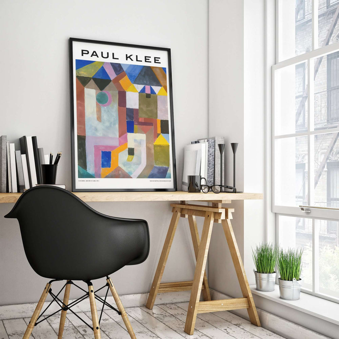 Paul Klee colorful abstract geometric poster art print displayed in a modern office setting with a black chair.