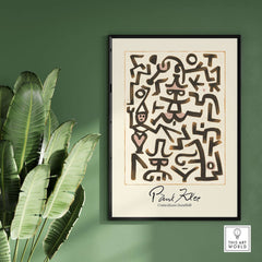 Paul Klee Comedians Handbill Abstract Figures Poster Modern Art Print showcased on wall with tropical plant.