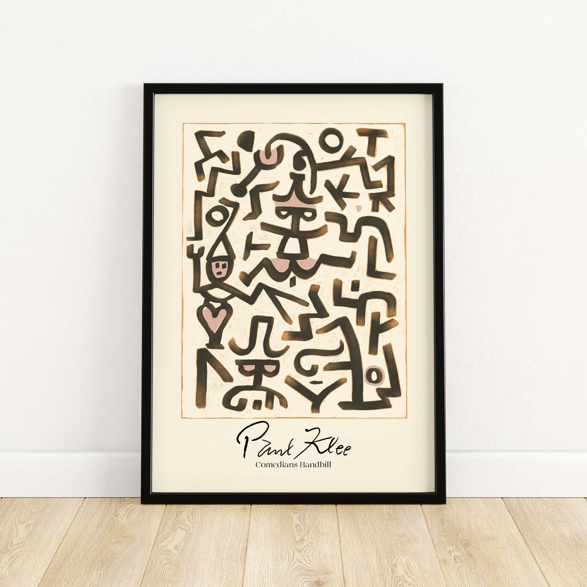 Paul Klee Comedians Handbill Abstract Figures Poster Modern Art Print in a black frame on a wooden floor.
