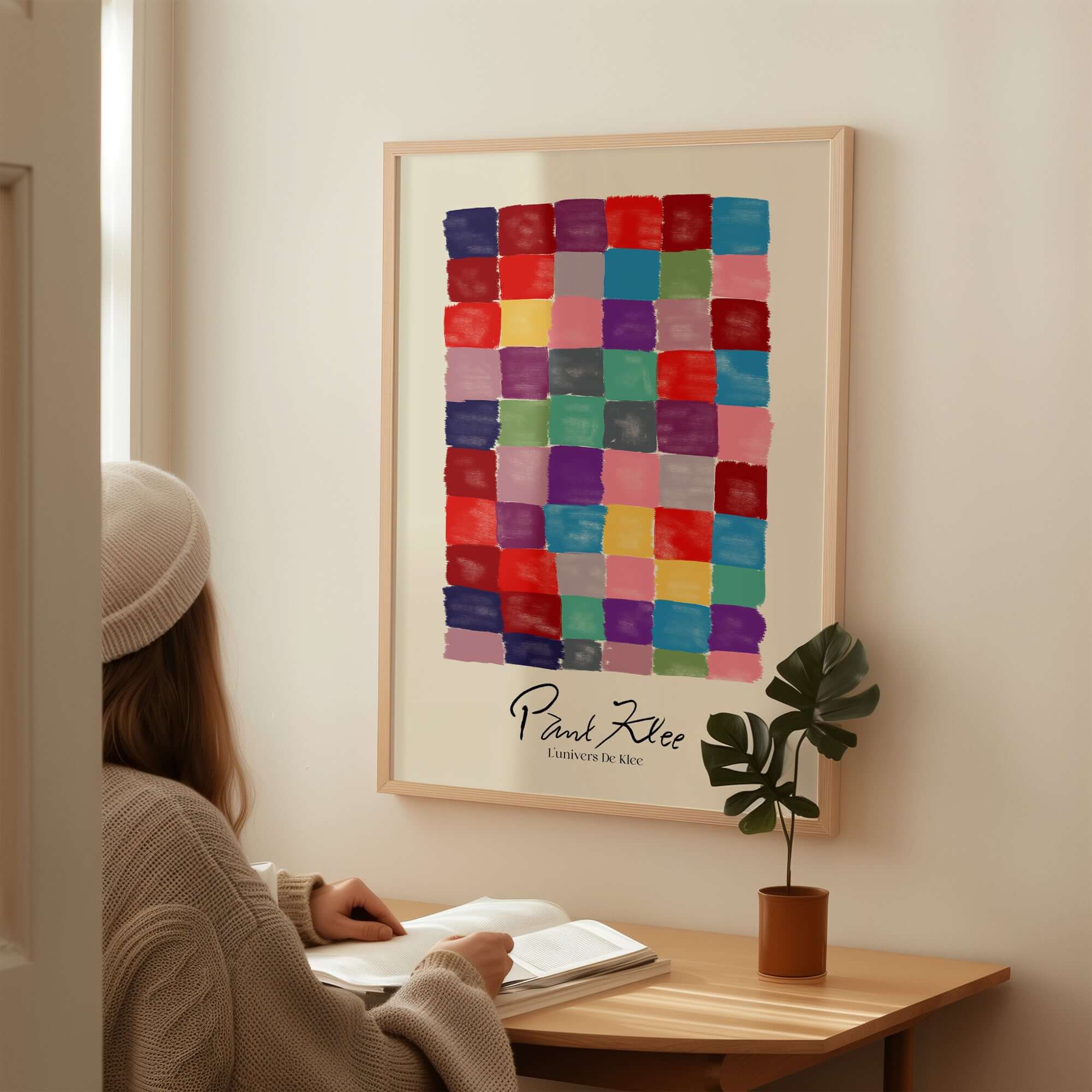Paul Klee L univers De Klee Colorful Squares Abstract Grid Poster Art Print displayed on a wall with a person studying.