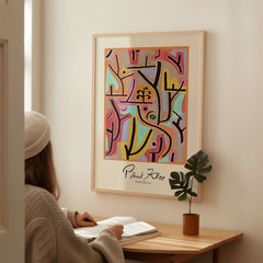 Paul Klee Park Bei Lu Colorful Abstract Landscape Poster Art Print displayed in a modern interior with person reading.