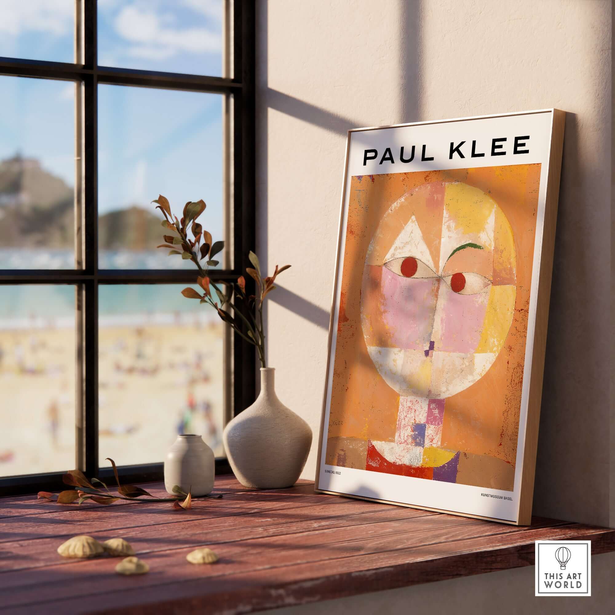 Paul Klee Senecio Head of Man Abstract Portrait Poster Art Print displayed on a sunny windowsill with beach view.
