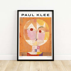 Paul Klee Senecio Head of Man Abstract Portrait Poster Art Print displayed in a black frame on a wooden floor.