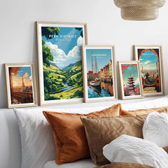 Framed Peak District Travel Print along with other city travel prints on a cozy couch.