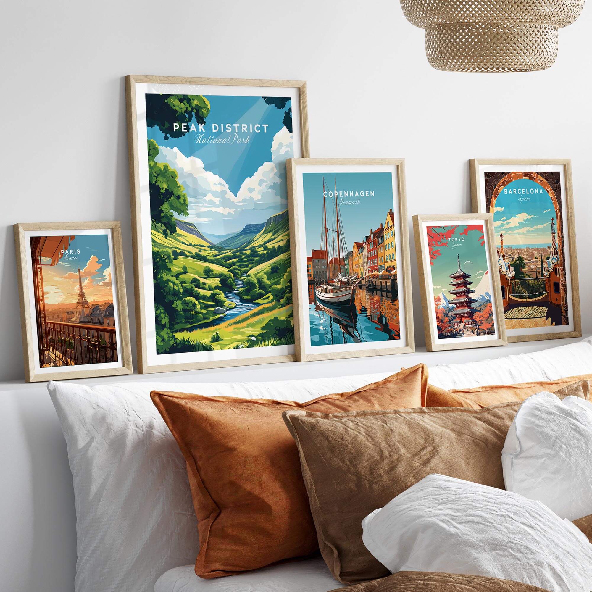 Framed Peak District Travel Print along with other city travel prints on a cozy couch.