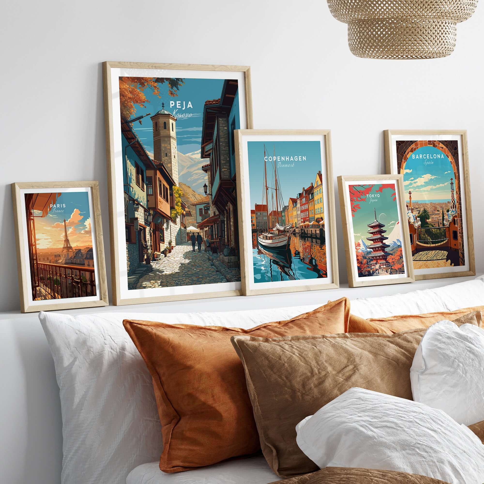Peja Canvas Print | Balkan City Wall Art displayed among other city-themed artworks on a modern sofa.