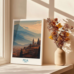 Peja Kosovo Mountain Town Art Print | Rugova Valley Panorama Poster displayed beside a vase with flowers in a sunlit room.