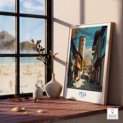 Peja Kosovo Old Town Street Art Print | Historic Tower View Poster displayed on a wooden table beside a window.