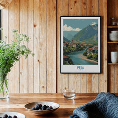Peja Kosovo River Valley Art Print | Mountain Town Scenery Poster displayed in a cozy wooden setting with vibrant nature.